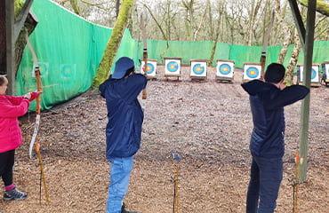 Couples trying archery at Adventure Now Manchester