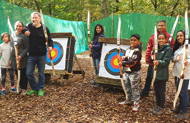 Adults friends have a go archery session at Adventure Now Manchester