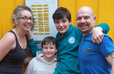 Family in-front of Catchphrase Quest leaderboard at Adventure Now Manchester