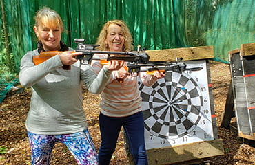 Family shooting a crossbow at Adventure Now Manchester
