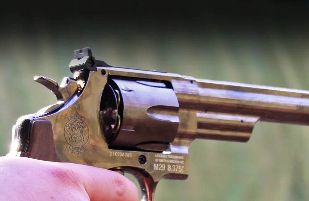 Silver Beretta pistol being held and pointed